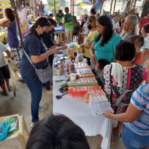 medical missionaries distribute necessary medicines to patients at clinic