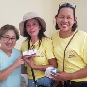 three women holding medicine boxes