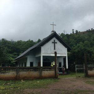 White church building with a foggy forest landscape
